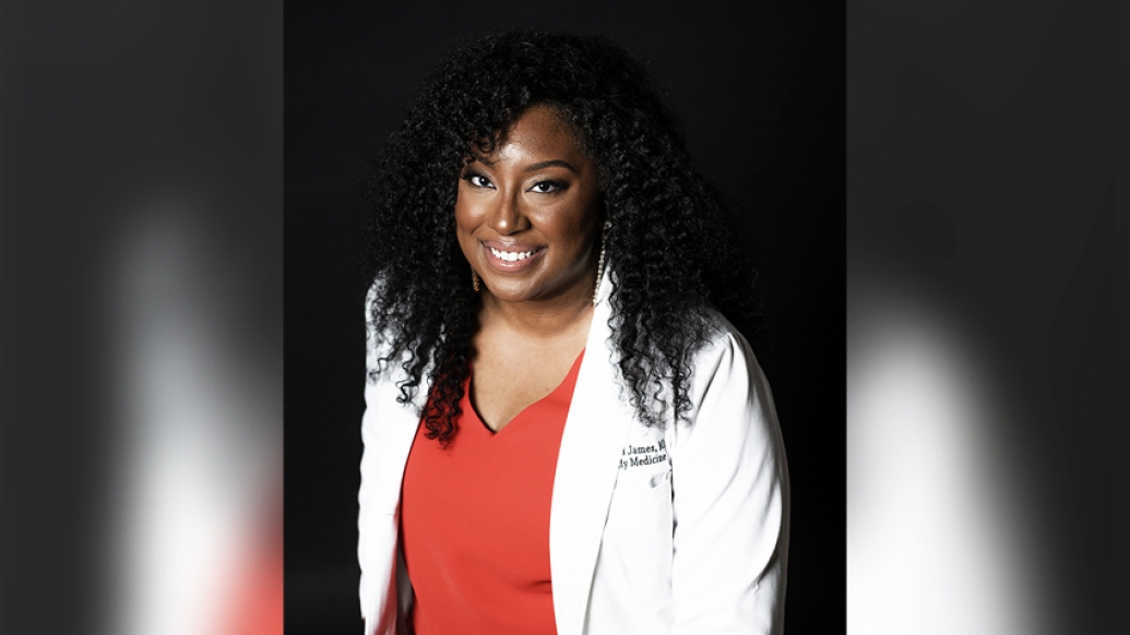doctors smiling headshot red shirt and white coat