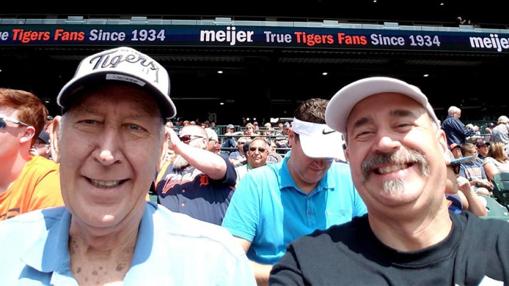 Dad and son at baseball game