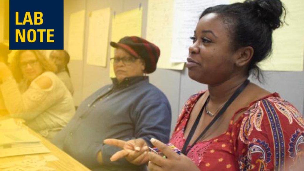 woman speaking in meeting conference table lab note yellow blue