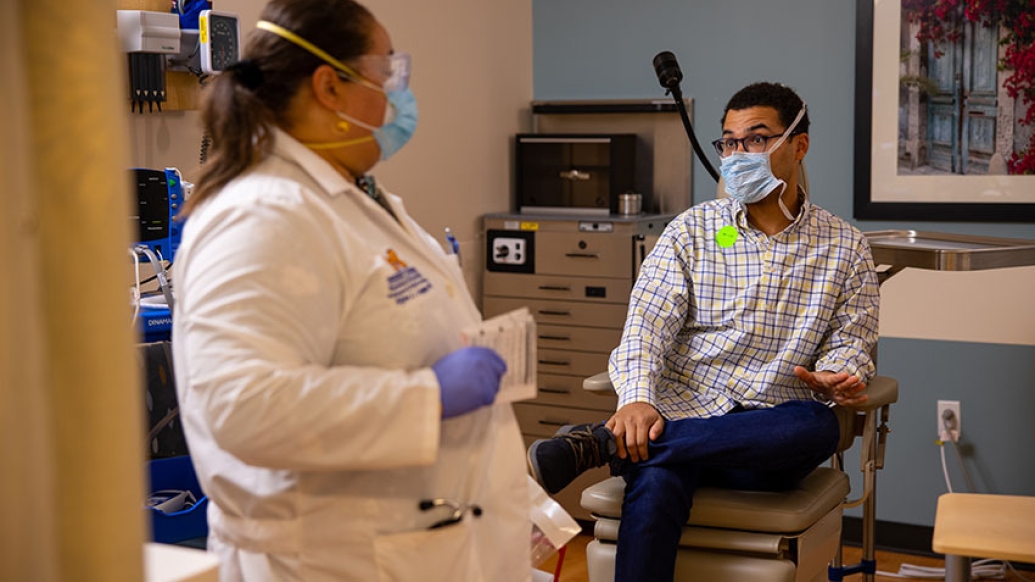 man talking with doctor in office