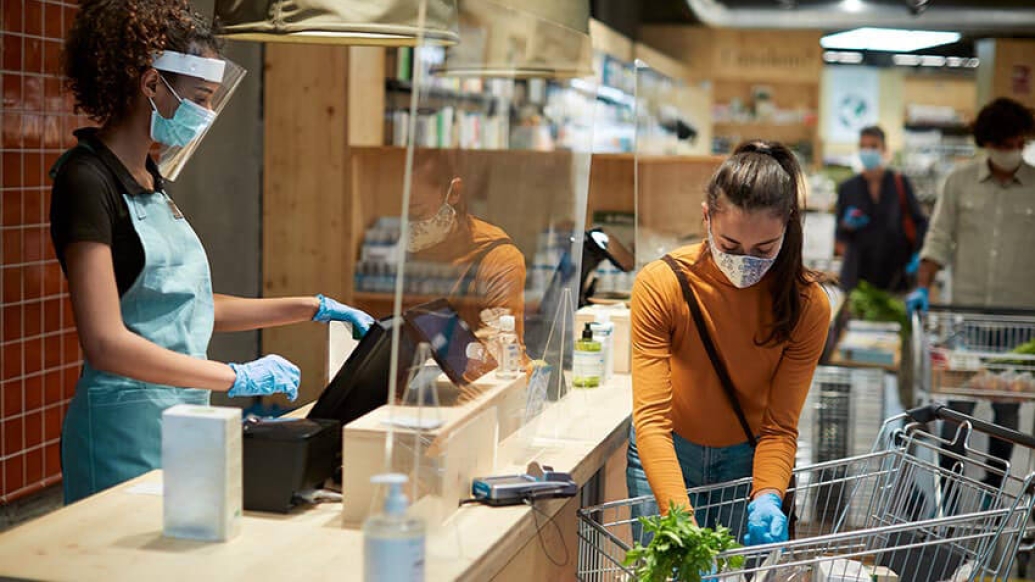 Social distancing checking out at grocery store