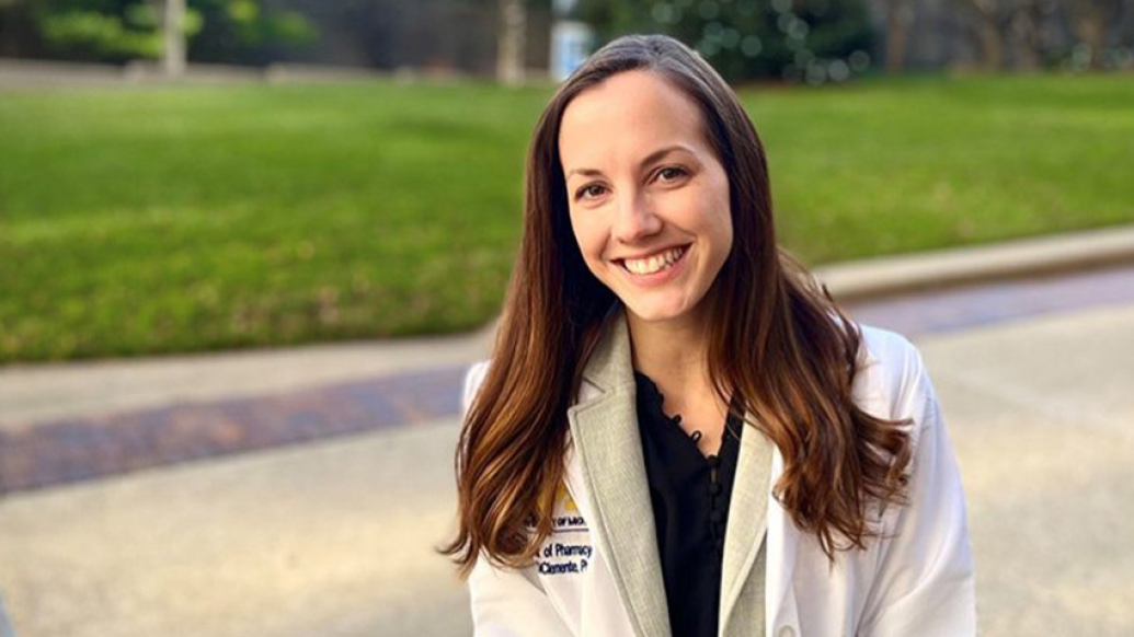 woman smiling white coat green grass