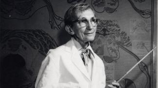 Photo of Elizabeth Crosby holding a pointer in a classroom