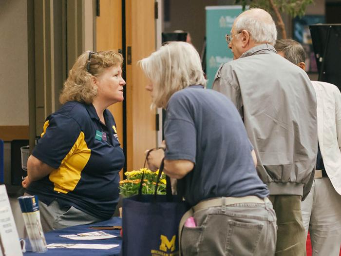 Group of seniors talk to each other at an event