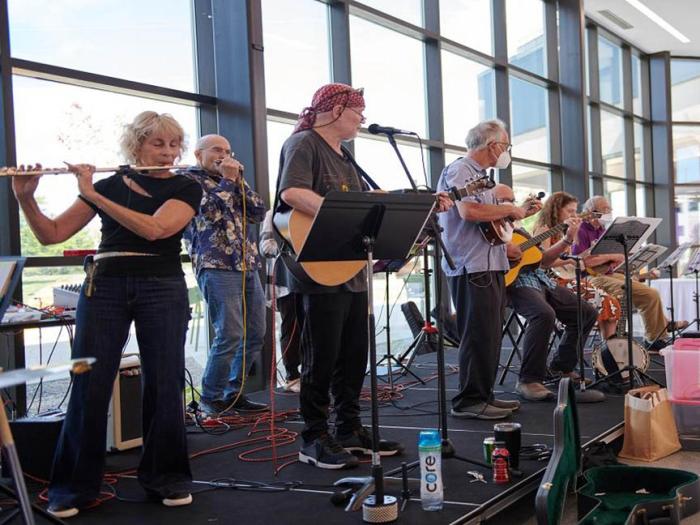 Group of older musicians playing on a stage