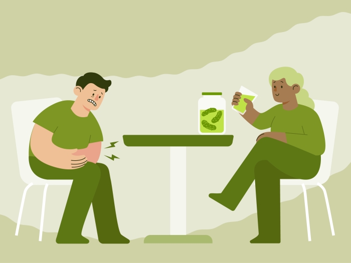 Graphic of a man and woman dressed in green sitting at a table that has a jar of pickles on it.