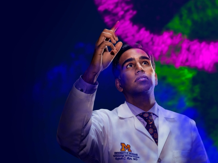 Dr. Rajesh Rao using his finger to create a pink line of