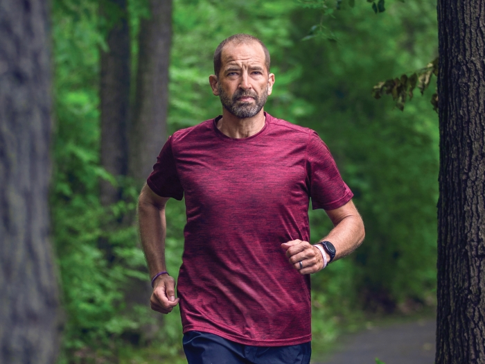 Michael Skaggs running on a trail in the woods
