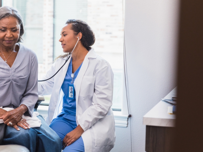 Senior Woman receiving Stethoscope Exam by Doctor