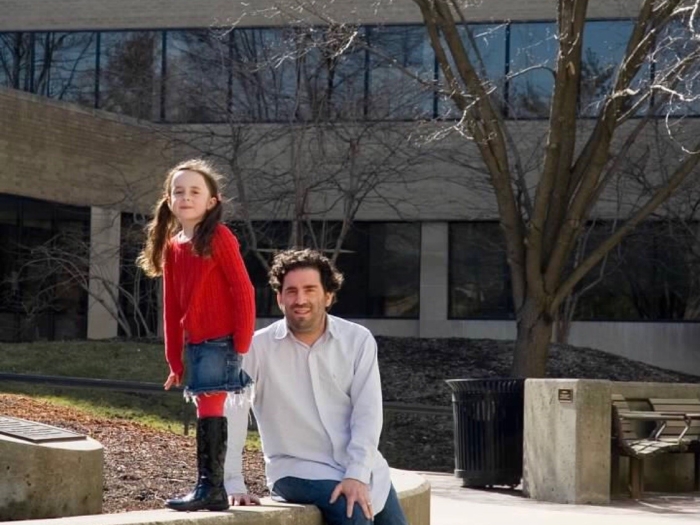 Emma and her dad pose for a photo outside