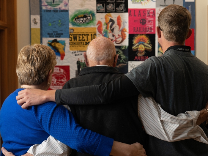backs of three people