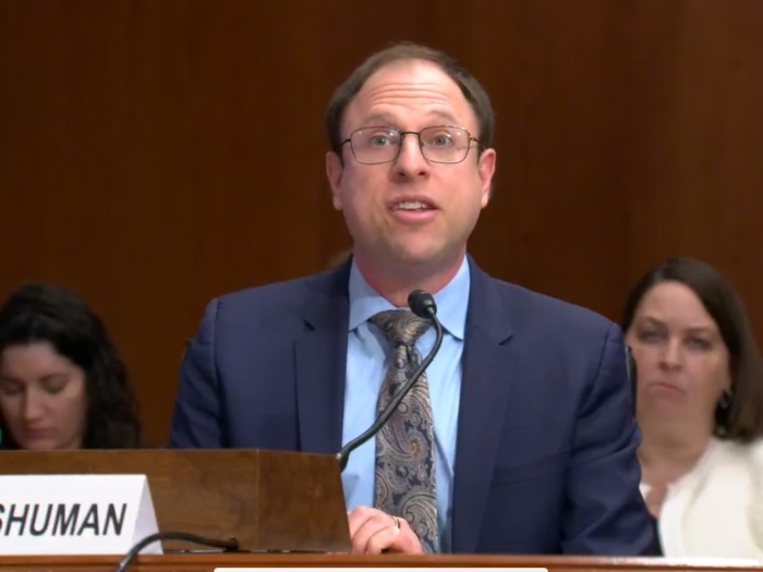 man speaking at podium
