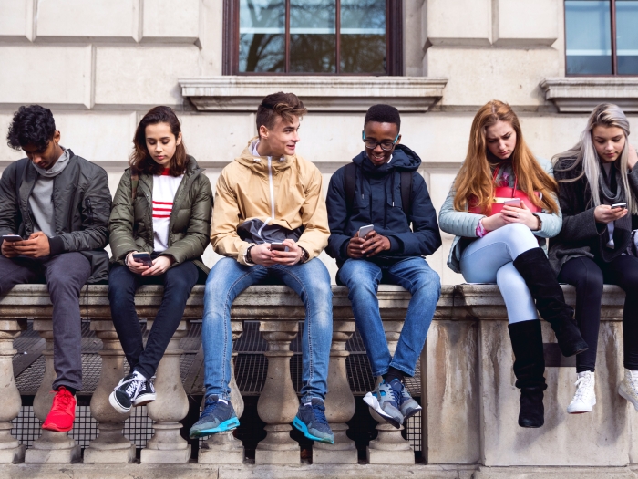 Teenagers Sitting Wall Phones Building