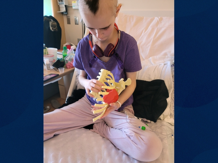 teen girl holding rib cage model