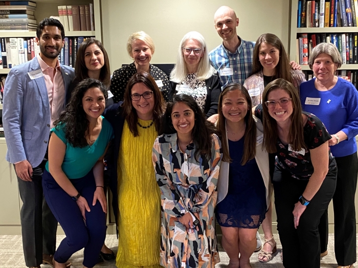 group of alums smiling at camera