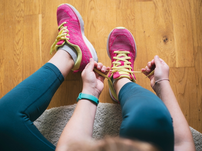 Person tying shoes on floor