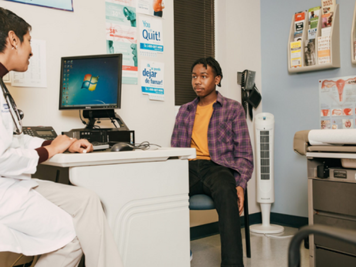 A doctor talking to a young patient.