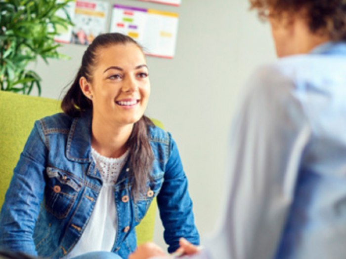 Teen smiles while talking to provider
