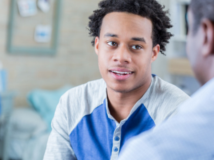 teen boy speaks with provider