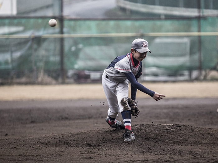 Boy pitching ball 