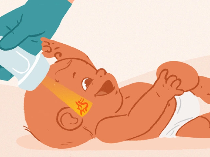 Hand with green gloves holding nsultrasound scanning a baby's head showing red vei 