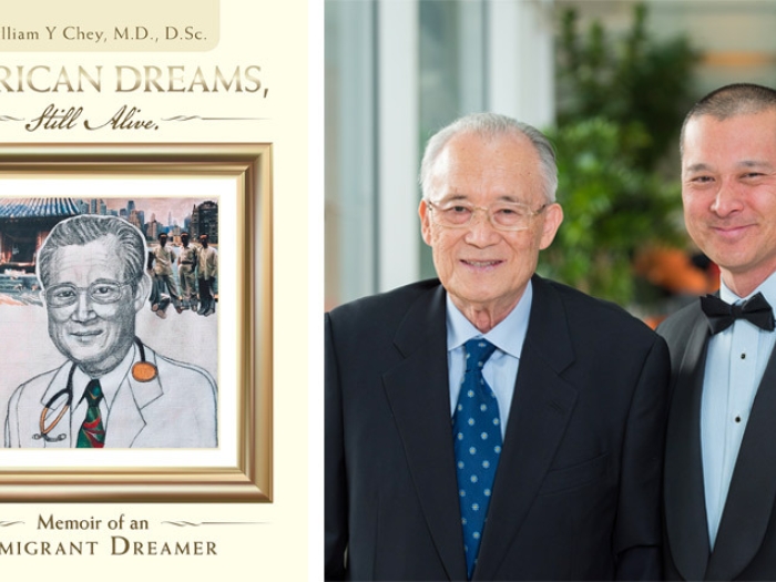 father and son standing together and book cover