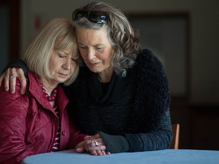 daughter hugging mother in dark room