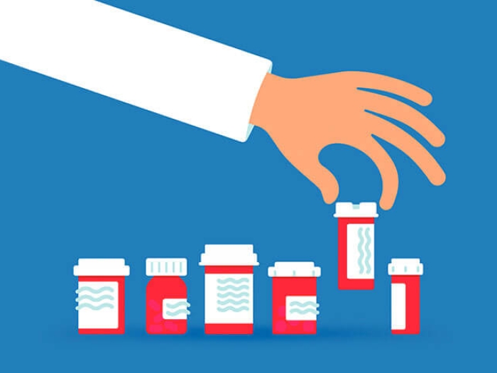 Doctor hand selecting a prescription bottle