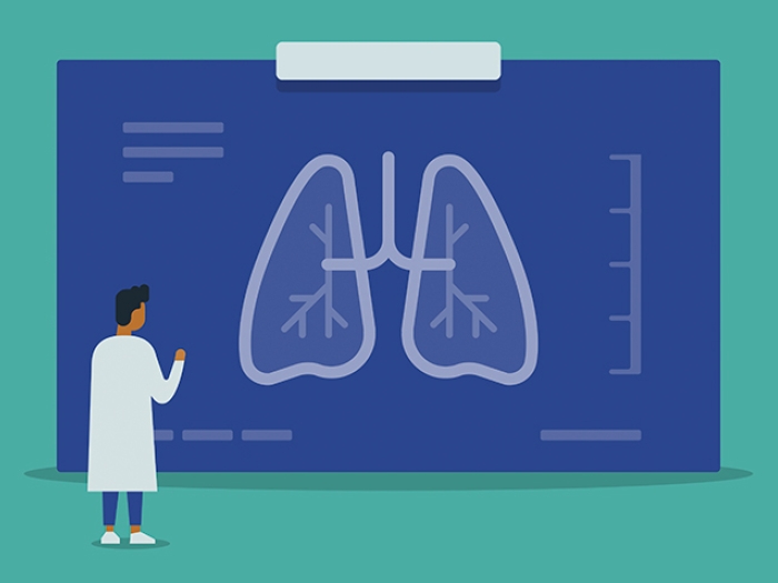 doctor in lab coat with blue xray of lungs