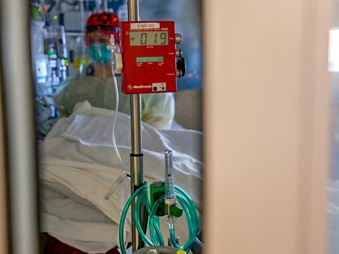 Photo of ECMO machine through small opening of door