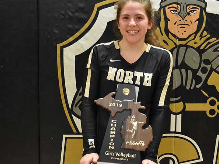 Emily posing with volleyball trophy