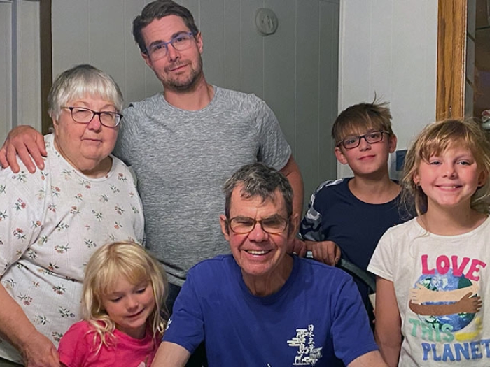Family smiling with children at table