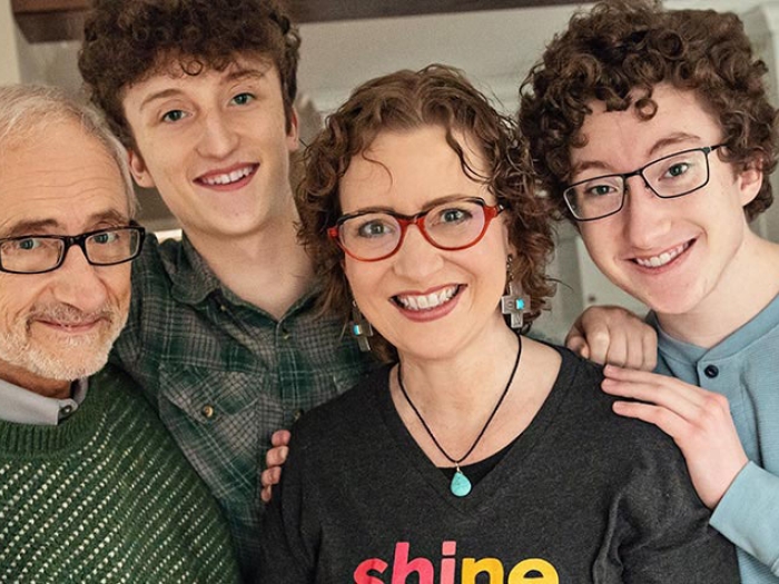 Family smiling and hugging one another