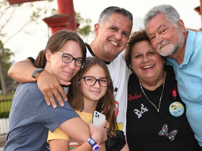 family smiling posing outdoors happy