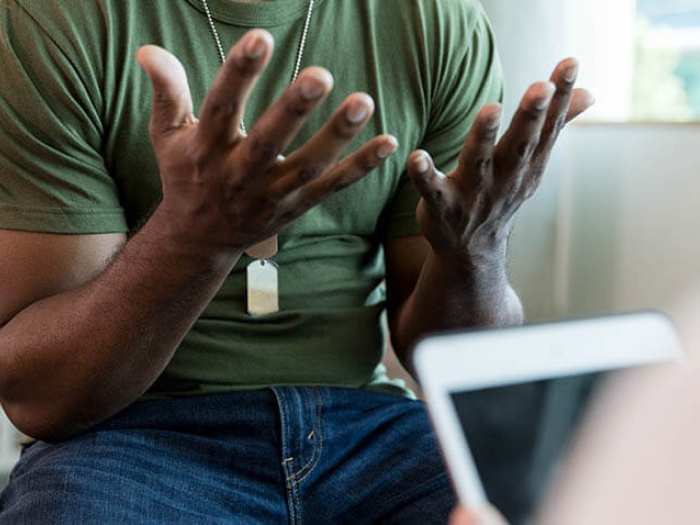 Frustrated military patient talking with doctor