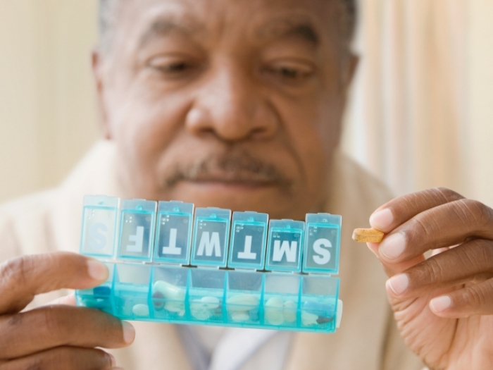 Man holding a pill box