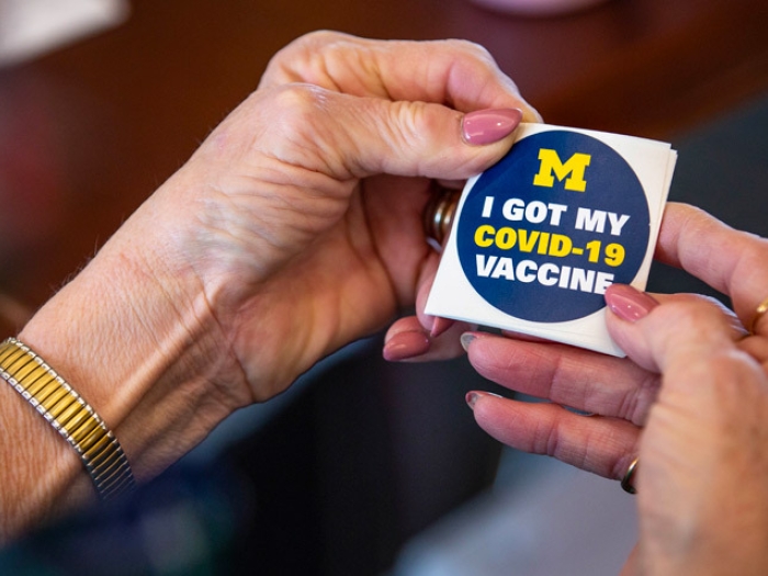 Hands Wristwatch Vaccination Sticker saying "I got my COVID vaccine"