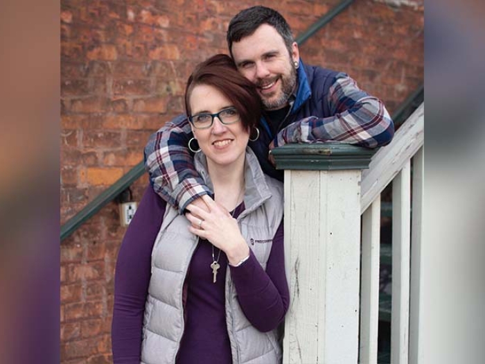 Husband and wife outside holding hands