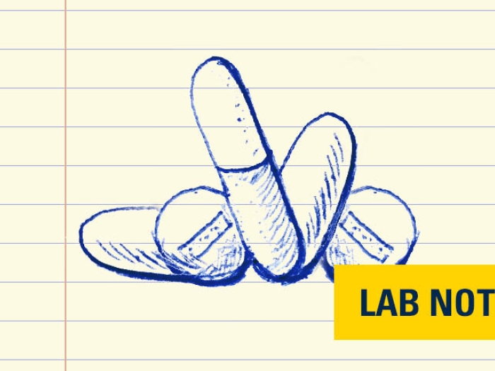 drawing in blue ink of pills on lined paper with yellow badge on bottom right that says lab note