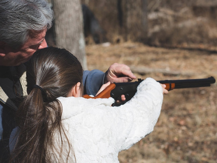 man girl shooting rifle