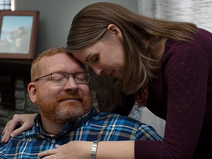 man woman smiling eyes closed