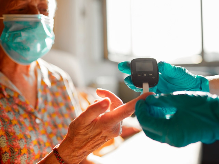  Masked Woman Blood Glucose Check