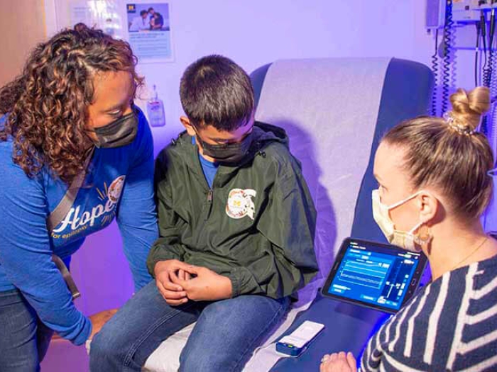 Mom and patient with doctor viewing brain waves