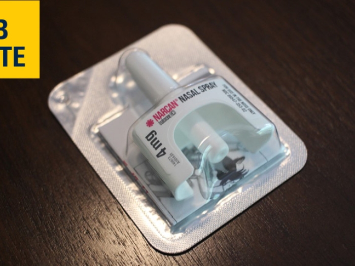 narcan nasal spray medication on table with lab note written in yellow background and navy font