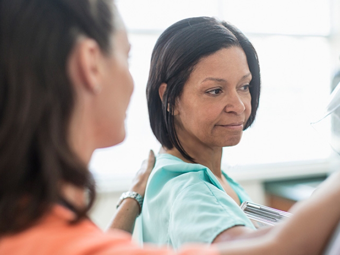 nurse and patient at mammogram machine scan close up