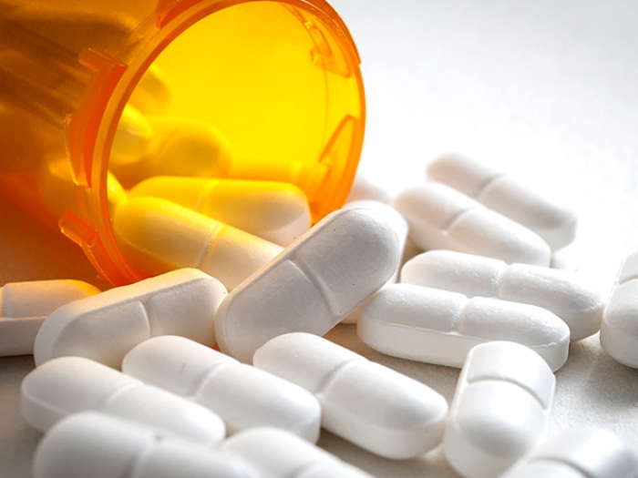 pills spilling out orange bottle