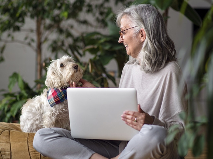 senior woman sitting with dog on lap