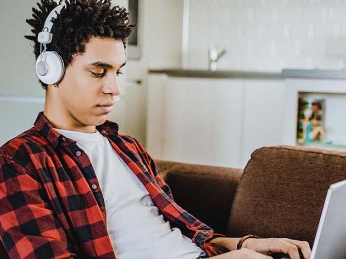 Student on laptop at home on couch