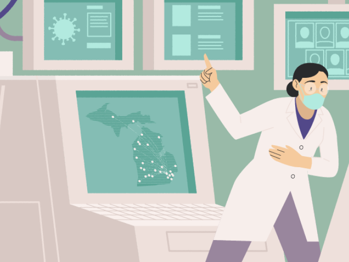 super computer with scientist in front of it showing COVID michigan data