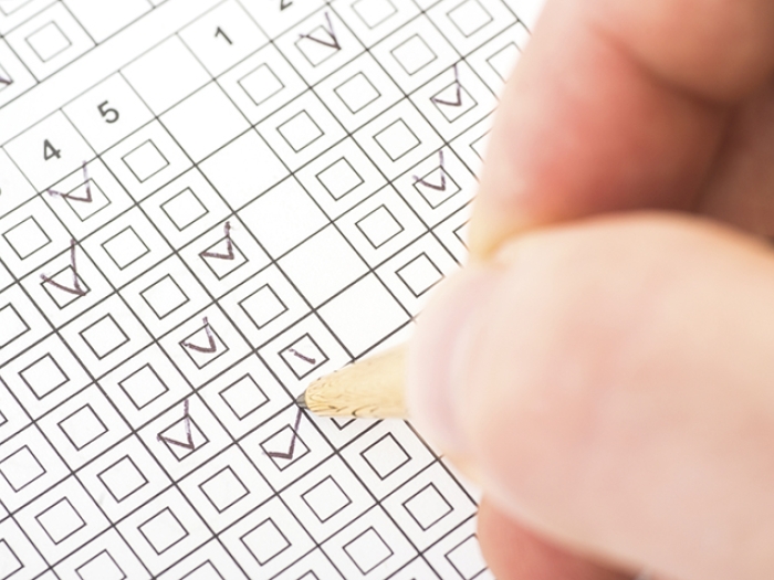 A hand completing a Huntington's Disease test